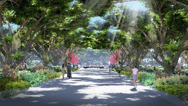 A tree-lined walkway with people. Red Singapore flags are visible in the distance. Sunlight shines through the trees.