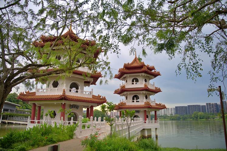A two pagodas next to a body of water with Fort Provintia in the background
AI-generated content may be incorrect.